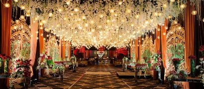 Elegant entrance and pathway decoration with floral arches and lights, creating a welcoming ambiance.